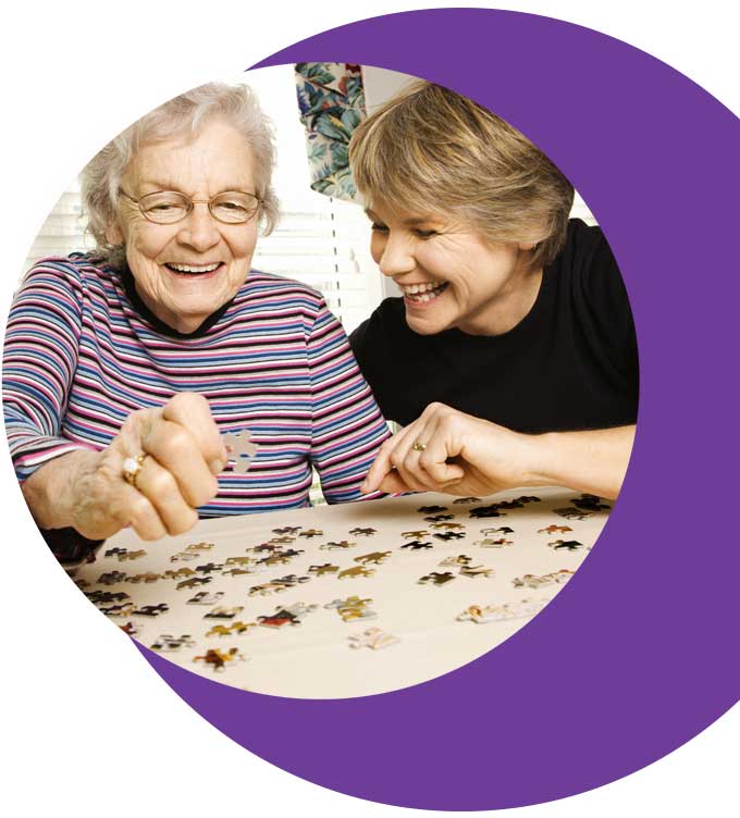 lady living at home with carer doing a puzzle photograph